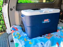 Insulated cooler located in very back of SUV on a clean sheet.